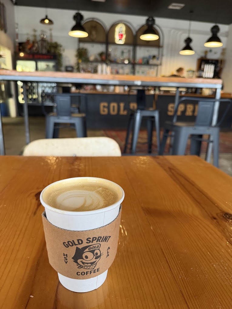 coffee on a table with a bar in back