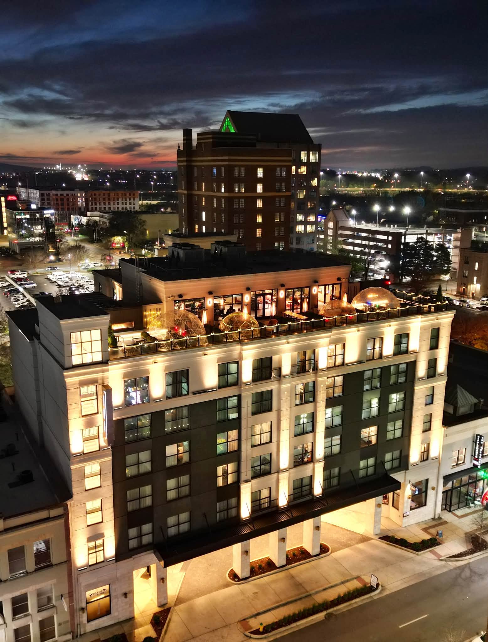 106 Jefferson hotel huntsville at night tall building topped with seasonal igloos for cocktails at Christmastime