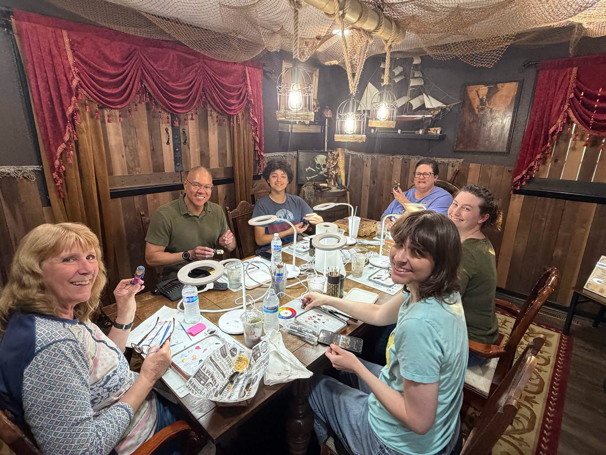 group smiling around a table