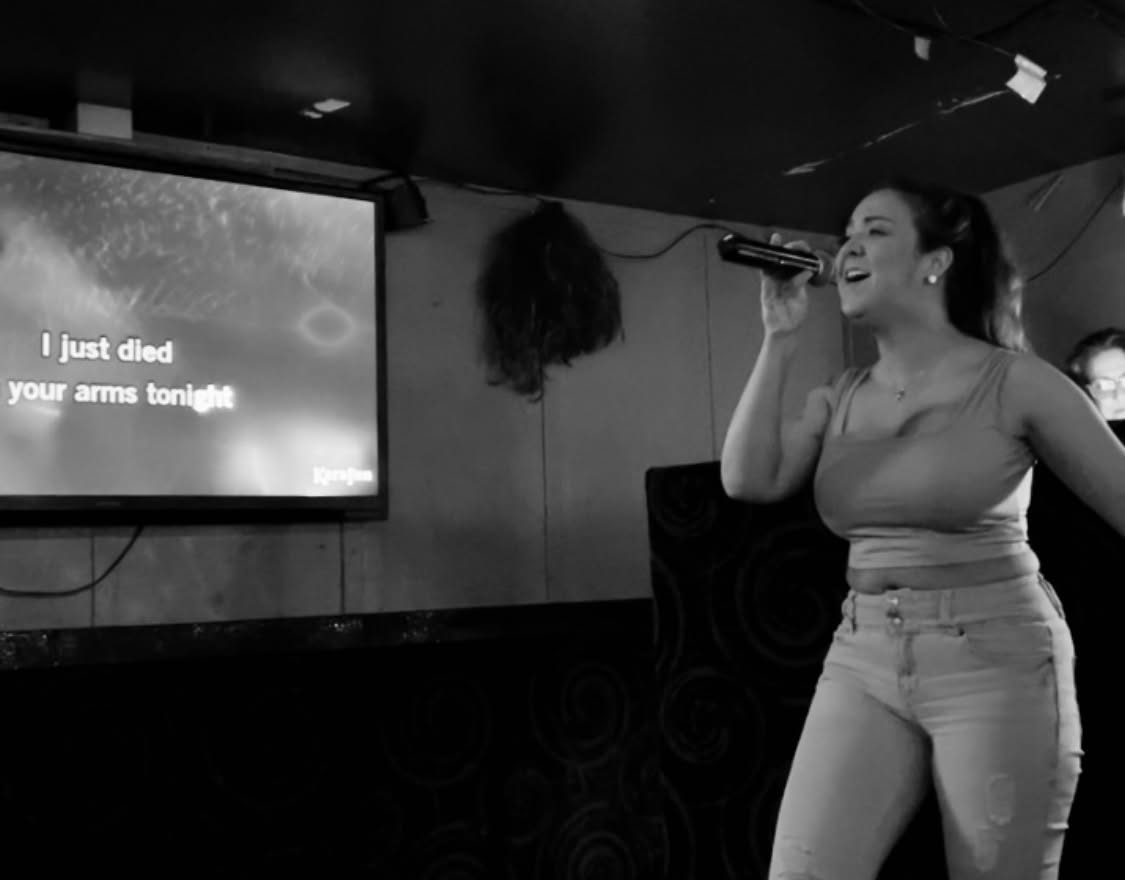 girl singing karaoke black and white