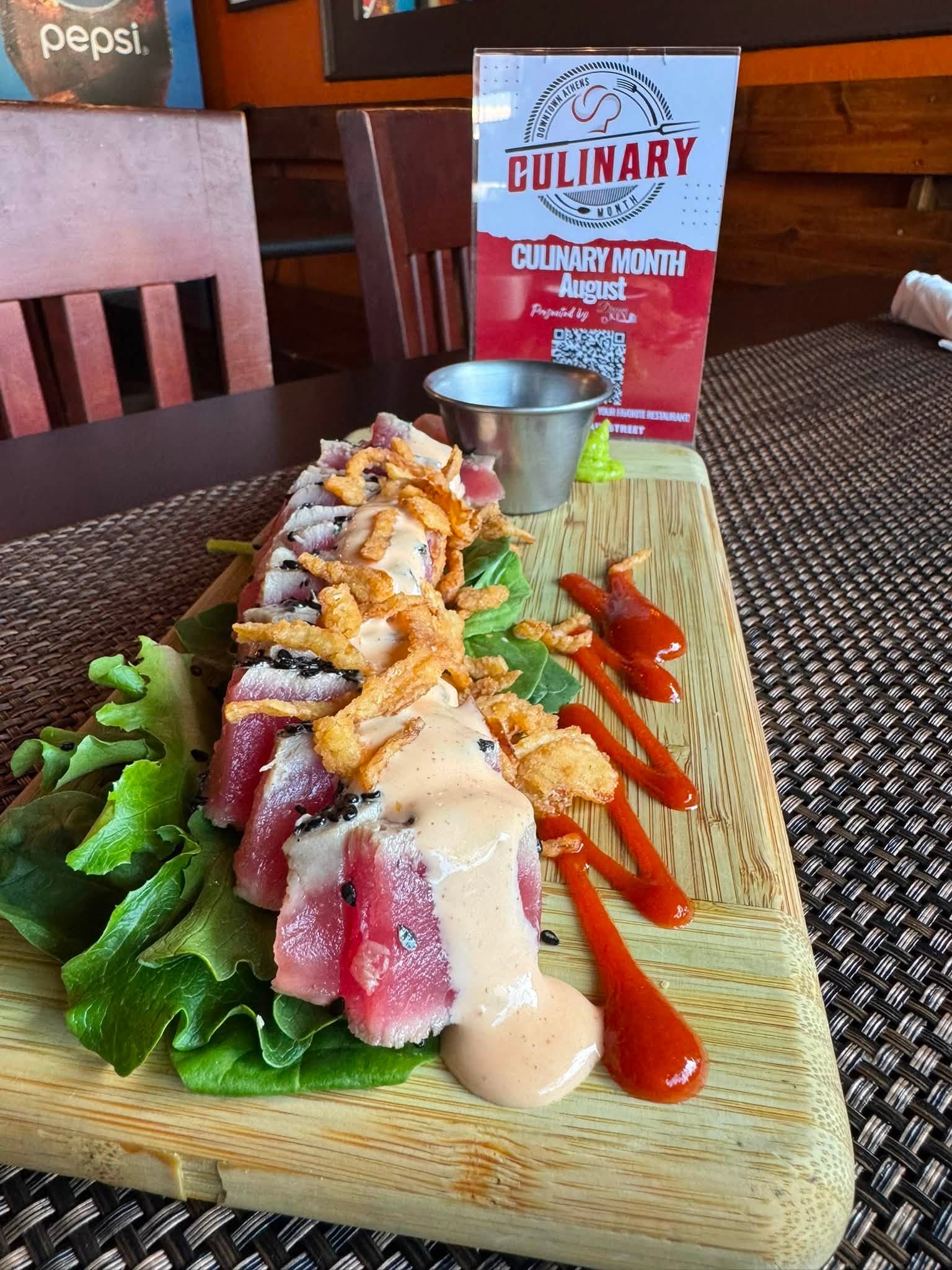 rare tuna displayed on a green salad