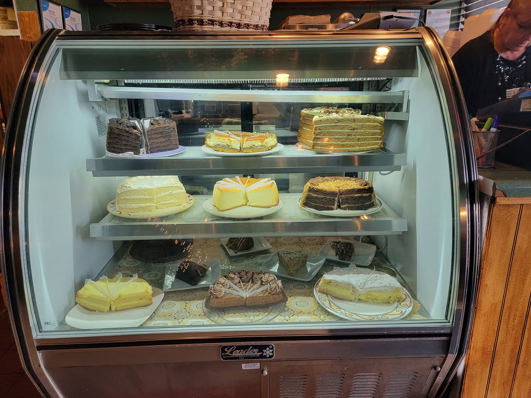 case full of cakes available by the slice in glass counter