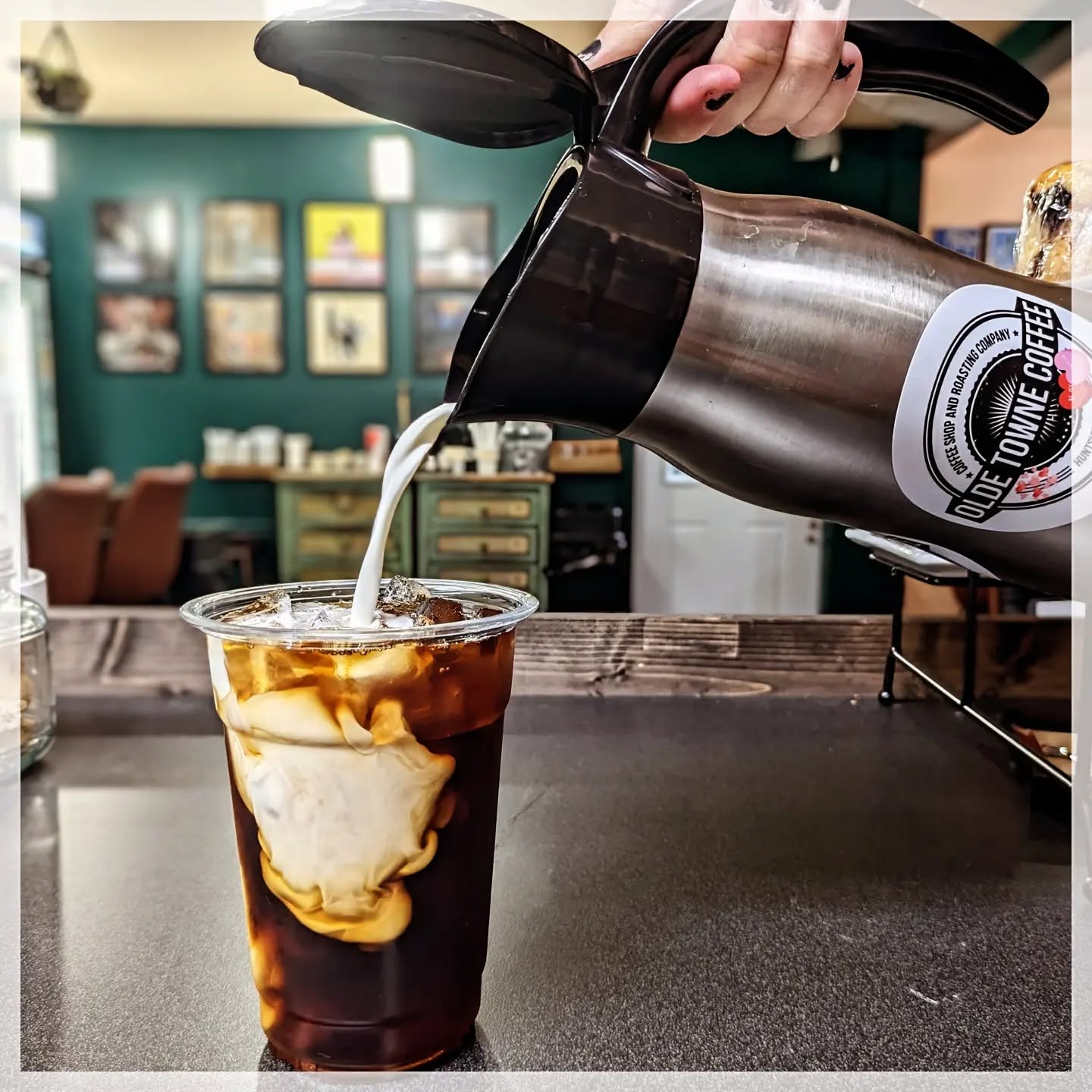 cold brew coffee with cream being hand poured in